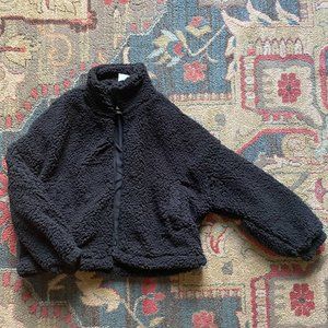 Black, fuzzy, small jacket by Urban Outfitters (never worn w/tags attached)